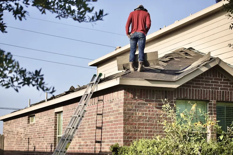 Professional roofer working on a residential roof in Medford Lakes